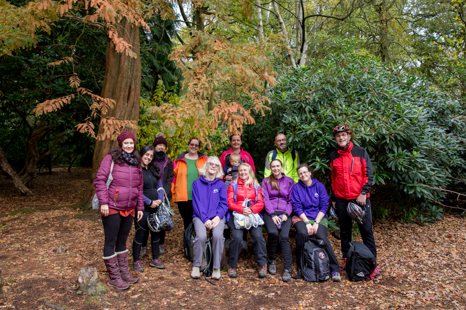 Group sit together in a wood