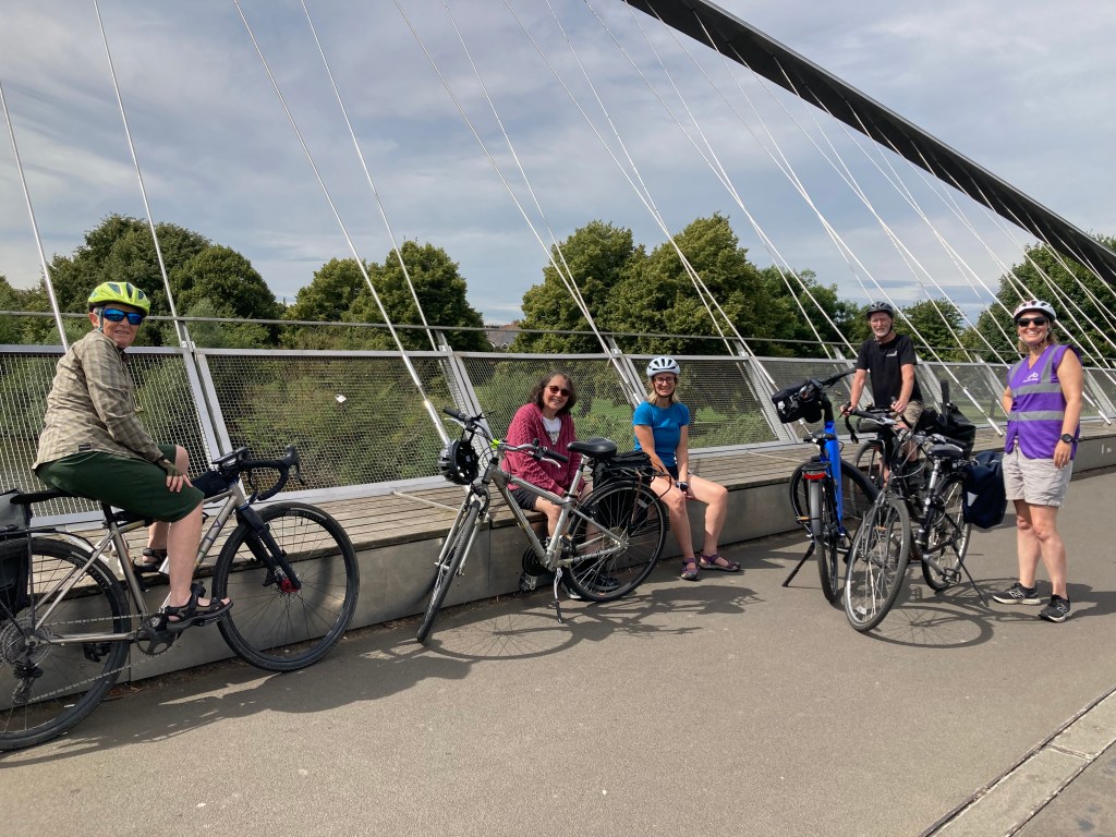 Group with bikes on bridge