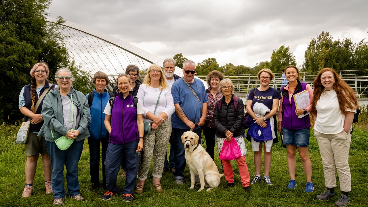 Group of people gather by Millennium Bridge