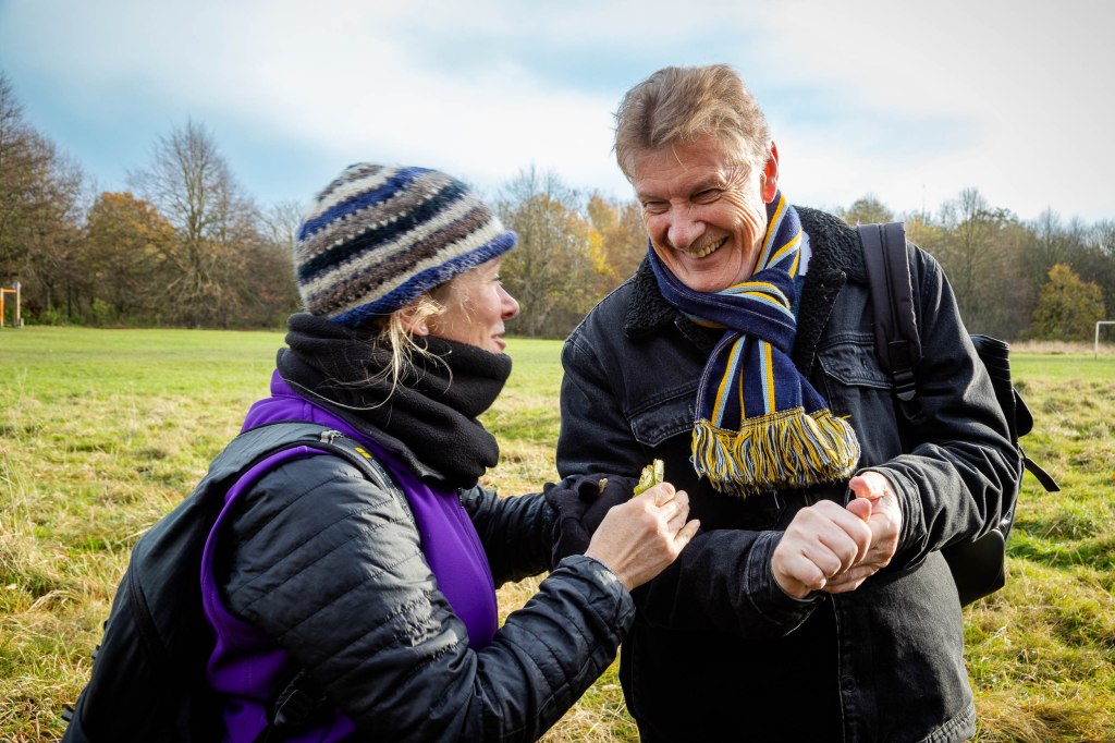 Two people outdoors laugh together