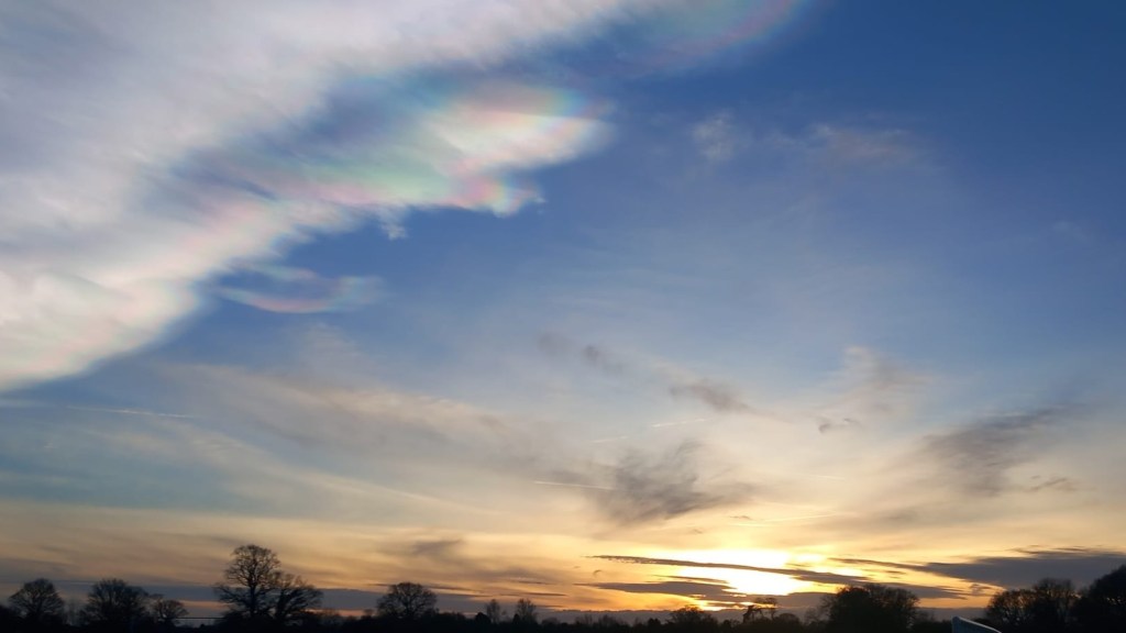 Sunset with orange and nacreous cloud