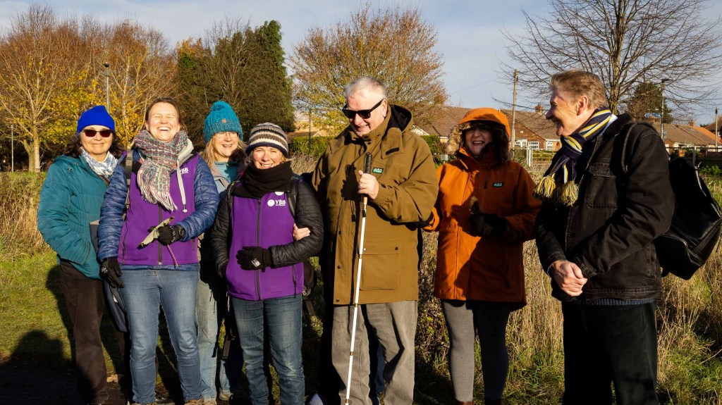 Group of people smiling together in winter sunshine